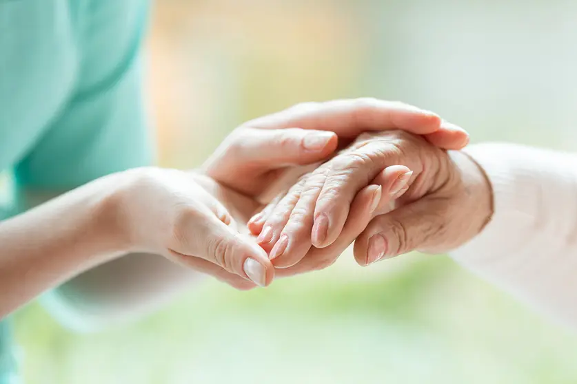 Senior person thanks the nurse for help during a meeting in a nursing home
