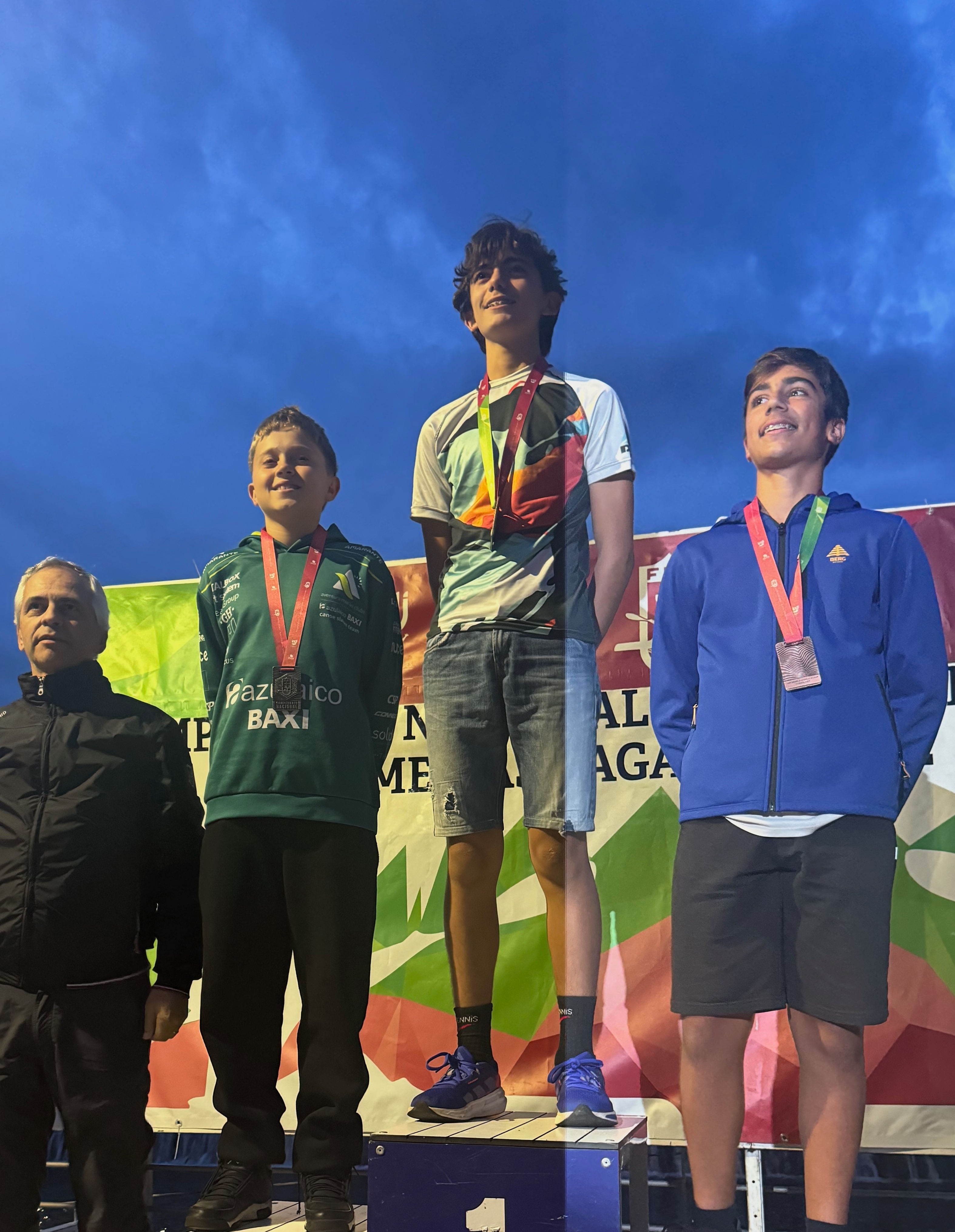 Los tres primeros clasificados de la categoría infantil masculina del Campeonato Nacional de Slalom de Esperanzas posan en el podio tras recibir sus medallas.